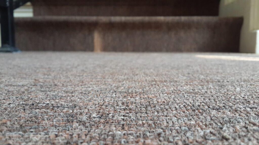 a close up of a carpet with a stair case in the background  – Mont Ivy Preschools