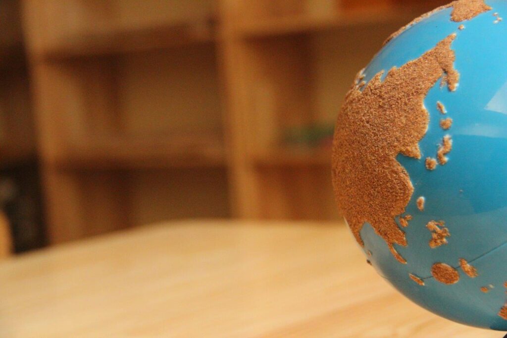 a blue and brown Sandpaper globe sitting on top of a wooden table – Mont Ivy Preschools